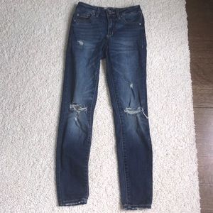 darker blue jeans with rips from garage